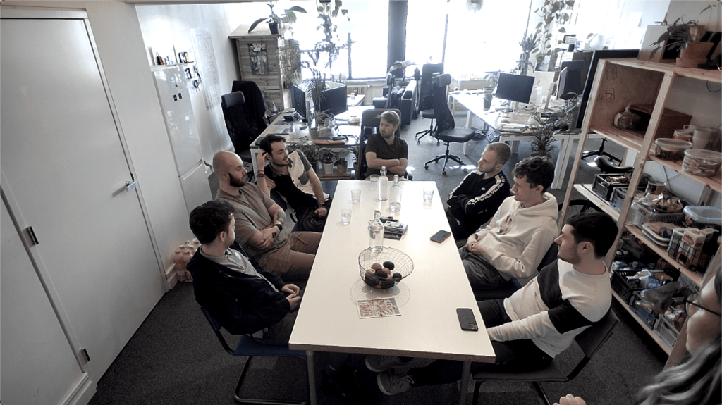 Mijn collega's van SIMDO zitten aan tafel en voeren samen de focusgroep & card sorting uit. Ik sta rechtsonder in de hoek. Hierna heb ik feedback gevraagd aan Erik.